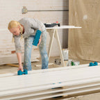 A person using the Crew 72 drying rack system to organize and maximize drying space efficiently.