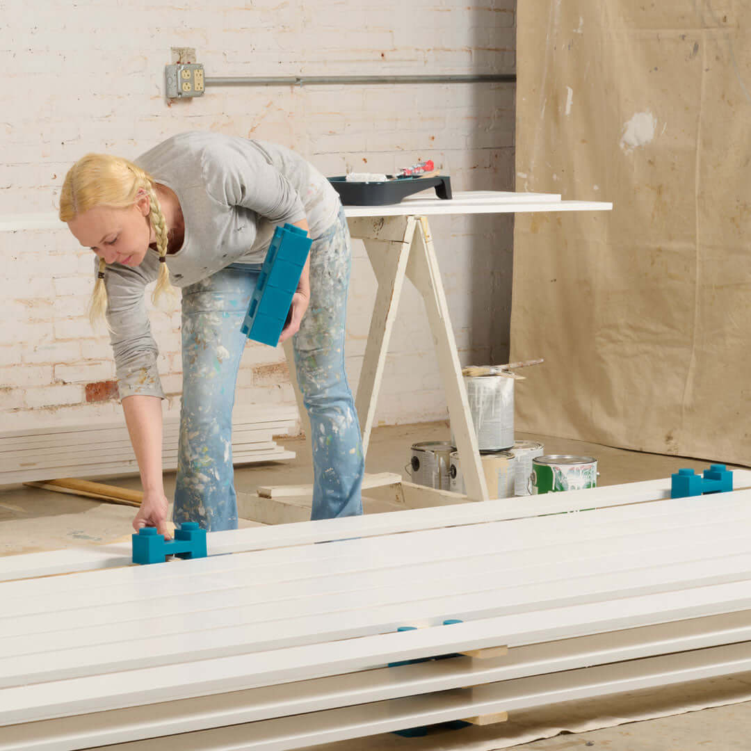 A person using the Crew 72 drying rack system to organize and maximize drying space efficiently.