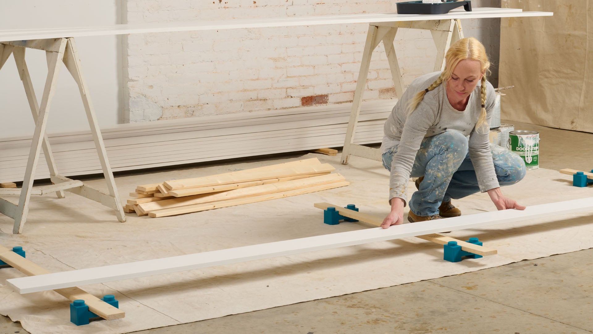 Professional Painter stacking painted boards to dry