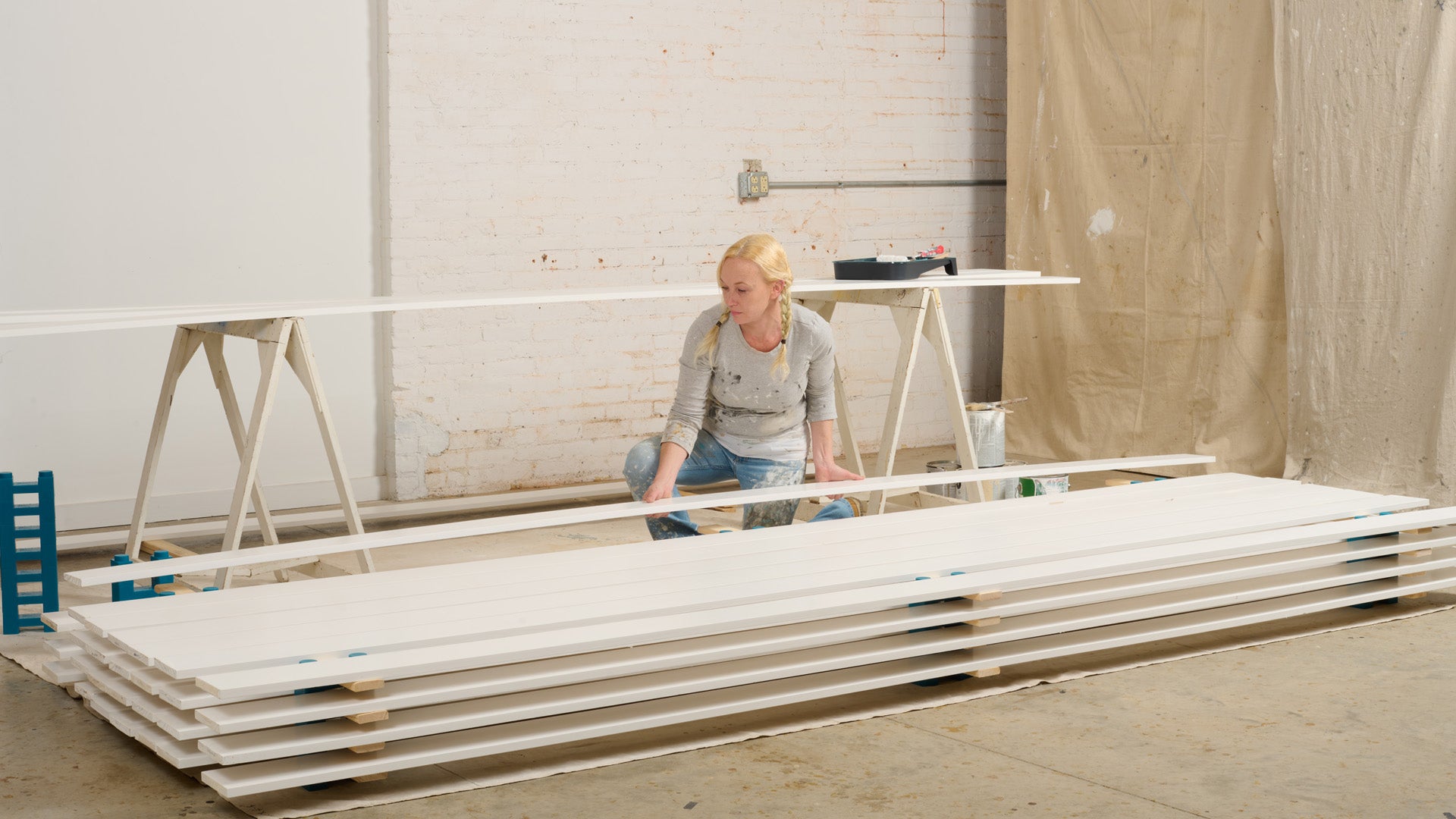 Painter adds last painted board to dry.