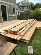 Wooden decking stained, stacked and drying.