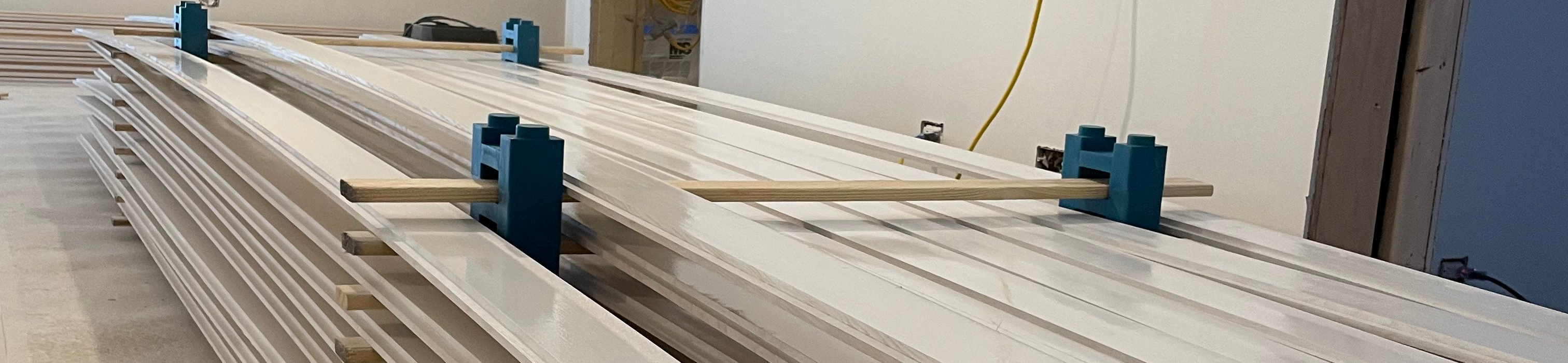 Freshly painted boards neatly stacked safely drying